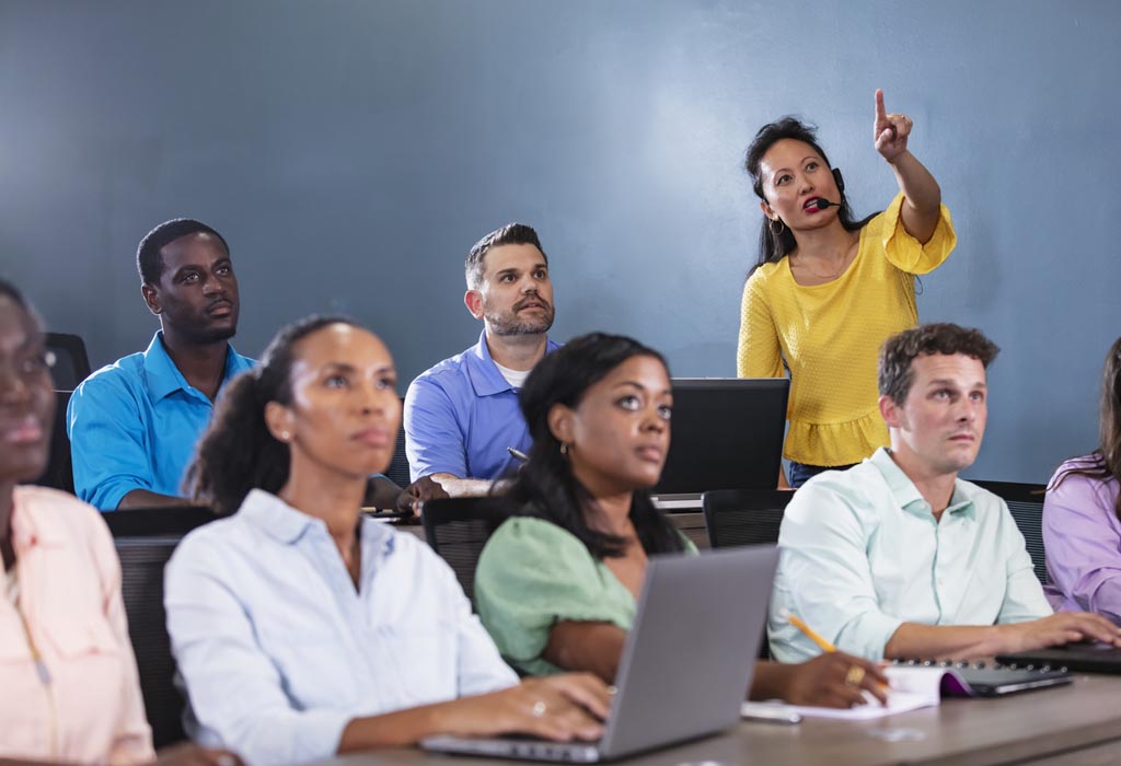 Technical School instructor teaching adult students how to program in Python.